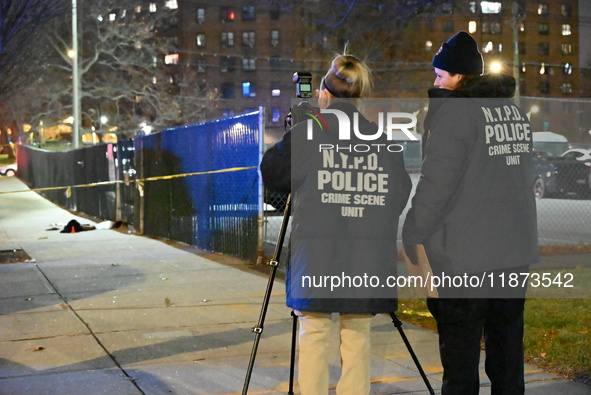 New York City Police Department crime scene investigators stage at the scene where a 26-year-old man identified as Tyreek Moore is shot and...