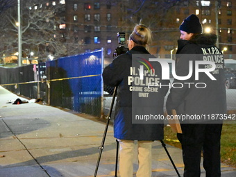 New York City Police Department crime scene investigators stage at the scene where a 26-year-old man identified as Tyreek Moore is shot and...