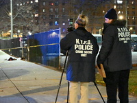 New York City Police Department crime scene investigators stage at the scene where a 26-year-old man identified as Tyreek Moore is shot and...