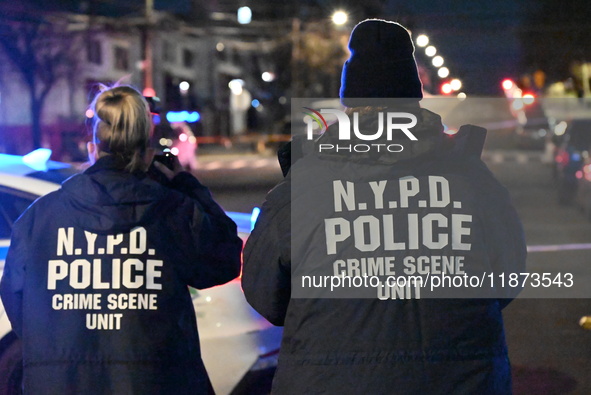 New York City Police Department crime scene investigators stage at the scene where a 26-year-old man identified as Tyreek Moore is shot and...