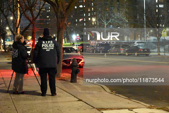 New York City Police Department crime scene investigators stage at the scene where a 26-year-old man identified as Tyreek Moore is shot and...