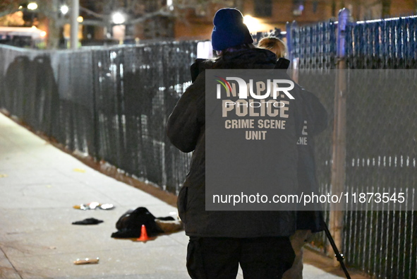 New York City Police Department crime scene investigators stage at the scene where a 26-year-old man identified as Tyreek Moore is shot and...