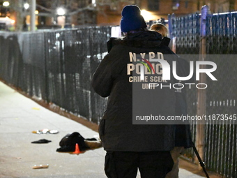 New York City Police Department crime scene investigators stage at the scene where a 26-year-old man identified as Tyreek Moore is shot and...