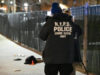 New York City Police Department crime scene investigators stage at the scene where a 26-year-old man identified as Tyreek Moore is shot and...