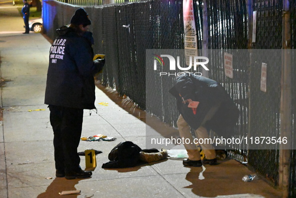 New York City Police Department crime scene investigators stage at the scene where a 26-year-old man identified as Tyreek Moore is shot and...