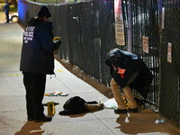 New York City Police Department crime scene investigators stage at the scene where a 26-year-old man identified as Tyreek Moore is shot and...