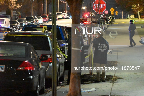 New York City Police Department crime scene investigators stage at the scene where a 26-year-old man identified as Tyreek Moore is shot and...