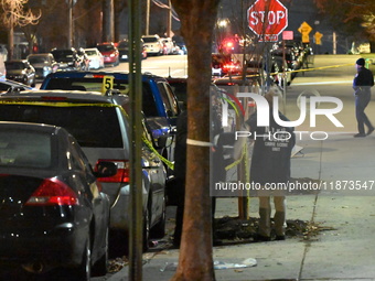 New York City Police Department crime scene investigators stage at the scene where a 26-year-old man identified as Tyreek Moore is shot and...