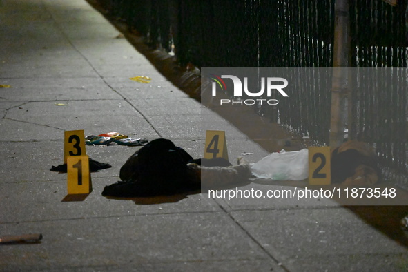 New York City Police Department crime scene investigators stage at the scene where a 26-year-old man identified as Tyreek Moore is shot and...