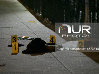 New York City Police Department crime scene investigators stage at the scene where a 26-year-old man identified as Tyreek Moore is shot and...