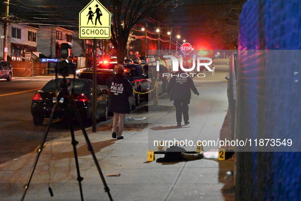 New York City Police Department crime scene investigators stage at the scene where a 26-year-old man identified as Tyreek Moore is shot and...