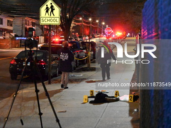 New York City Police Department crime scene investigators stage at the scene where a 26-year-old man identified as Tyreek Moore is shot and...