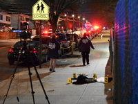 New York City Police Department crime scene investigators stage at the scene where a 26-year-old man identified as Tyreek Moore is shot and...