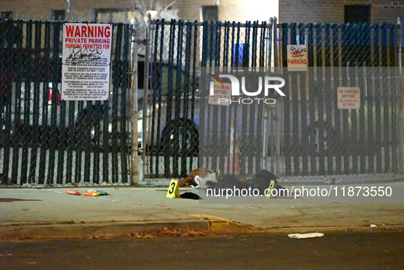 New York City Police Department crime scene investigators stage at the scene where a 26-year-old man identified as Tyreek Moore is shot and...