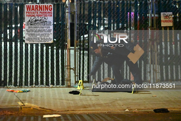 New York City Police Department crime scene investigators stage at the scene where a 26-year-old man identified as Tyreek Moore is shot and...