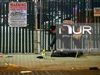 New York City Police Department crime scene investigators stage at the scene where a 26-year-old man identified as Tyreek Moore is shot and...