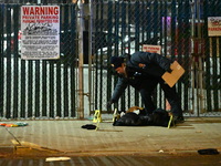 New York City Police Department crime scene investigators stage at the scene where a 26-year-old man identified as Tyreek Moore is shot and...