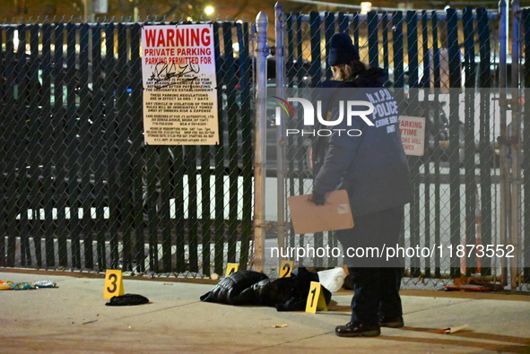 New York City Police Department crime scene investigators stage at the scene where a 26-year-old man identified as Tyreek Moore is shot and...