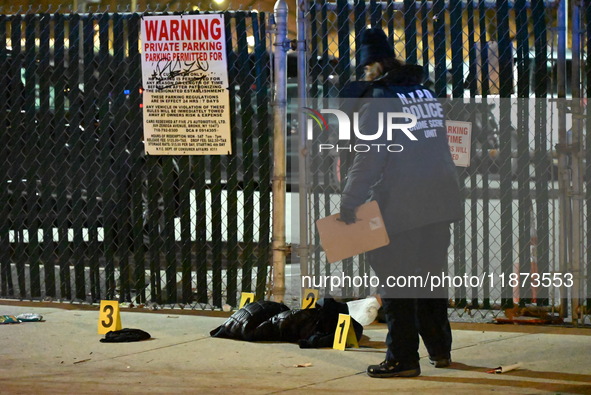 New York City Police Department crime scene investigators stage at the scene where a 26-year-old man identified as Tyreek Moore is shot and...