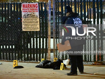 New York City Police Department crime scene investigators stage at the scene where a 26-year-old man identified as Tyreek Moore is shot and...