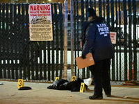 New York City Police Department crime scene investigators stage at the scene where a 26-year-old man identified as Tyreek Moore is shot and...