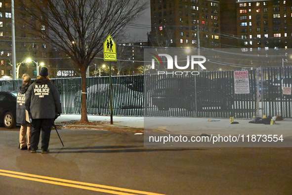 New York City Police Department crime scene investigators stage at the scene where a 26-year-old man identified as Tyreek Moore is shot and...