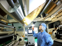 A worker works on the production line of a pharmaceutical packaging workshop in Lianyungang, China, on December 16, 2024. (