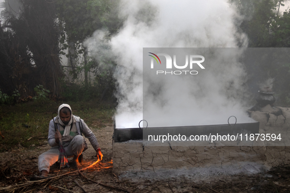 Workers prepare date jaggery after collecting juice from date palm trees in Magura, Bangladesh, on January 16, 2024. The production of date...