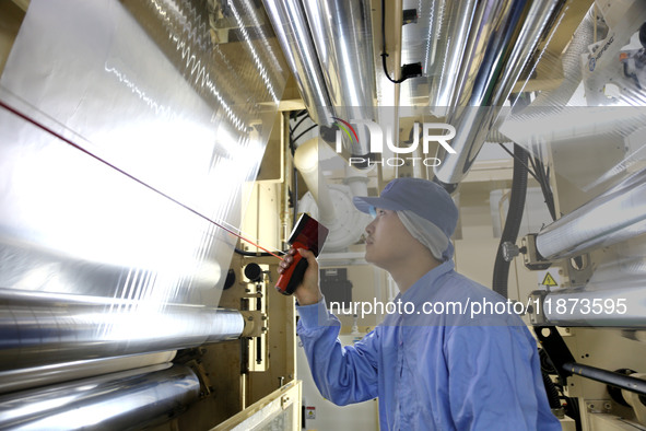 A worker works on the production line of a pharmaceutical packaging workshop in Lianyungang, China, on December 16, 2024. 