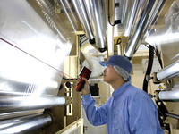 A worker works on the production line of a pharmaceutical packaging workshop in Lianyungang, China, on December 16, 2024. (