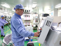 A worker works on the production line of a pharmaceutical packaging workshop in Lianyungang, China, on December 16, 2024. (