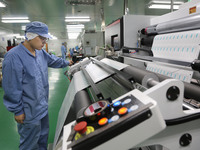 A worker works on the production line of a pharmaceutical packaging workshop in Lianyungang, China, on December 16, 2024. (