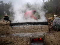 Workers prepare date jaggery after collecting juice from date palm trees in Magura, Bangladesh, on January 16, 2024. The production of date...