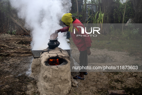 Workers prepare date jaggery after collecting juice from date palm trees in Magura, Bangladesh, on January 16, 2024. The production of date...