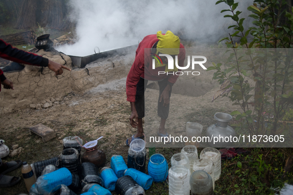 Workers prepare date jaggery after collecting juice from date palm trees in Magura, Bangladesh, on January 16, 2024. The production of date...