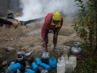 Workers prepare date jaggery after collecting juice from date palm trees in Magura, Bangladesh, on January 16, 2024. The production of date...