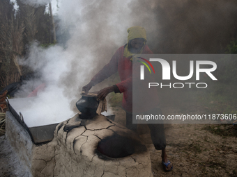 Workers prepare date jaggery after collecting juice from date palm trees in Magura, Bangladesh, on January 16, 2024. The production of date...