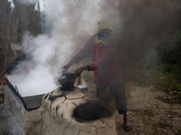 Workers prepare date jaggery after collecting juice from date palm trees in Magura, Bangladesh, on January 16, 2024. The production of date...