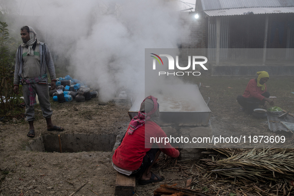 Workers prepare date jaggery after collecting juice from date palm trees in Magura, Bangladesh, on January 16, 2024. The production of date...