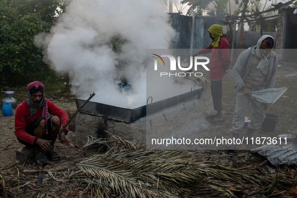 Workers prepare date jaggery after collecting juice from date palm trees in Magura, Bangladesh, on January 16, 2024. The production of date...