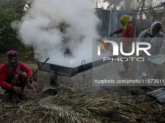 Workers prepare date jaggery after collecting juice from date palm trees in Magura, Bangladesh, on January 16, 2024. The production of date...