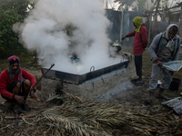 Workers prepare date jaggery after collecting juice from date palm trees in Magura, Bangladesh, on January 16, 2024. The production of date...