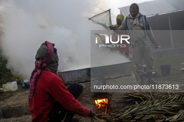 Workers prepare date jaggery after collecting juice from date palm trees in Magura, Bangladesh, on January 16, 2024. The production of date...