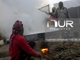 Workers prepare date jaggery after collecting juice from date palm trees in Magura, Bangladesh, on January 16, 2024. The production of date...