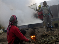 Workers prepare date jaggery after collecting juice from date palm trees in Magura, Bangladesh, on January 16, 2024. The production of date...