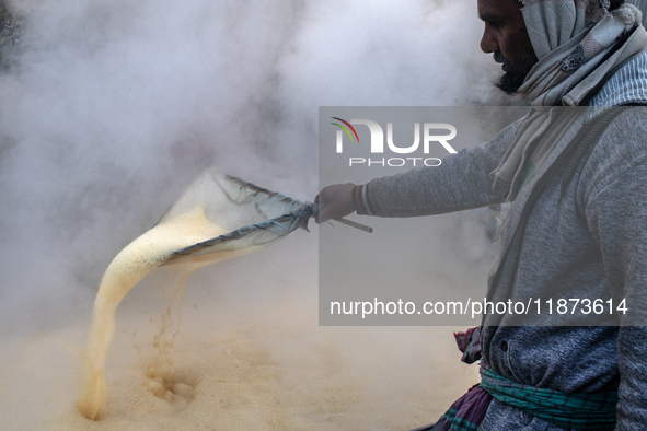 Workers prepare date jaggery after collecting juice from date palm trees in Magura, Bangladesh, on January 16, 2024. The production of date...