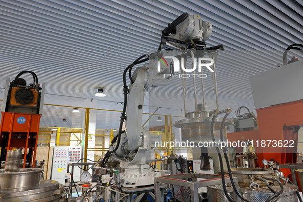 A robotic arm produces optical core products in an unmanned workshop at an enterprise in the Zaozhuang Economic Development Zone in Zaozhuan...