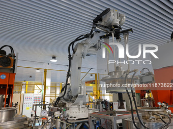 A robotic arm produces optical core products in an unmanned workshop at an enterprise in the Zaozhuang Economic Development Zone in Zaozhuan...