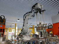 A robotic arm produces optical core products in an unmanned workshop at an enterprise in the Zaozhuang Economic Development Zone in Zaozhuan...