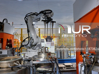 A robotic arm produces optical core products in an unmanned workshop at an enterprise in the Zaozhuang Economic Development Zone in Zaozhuan...